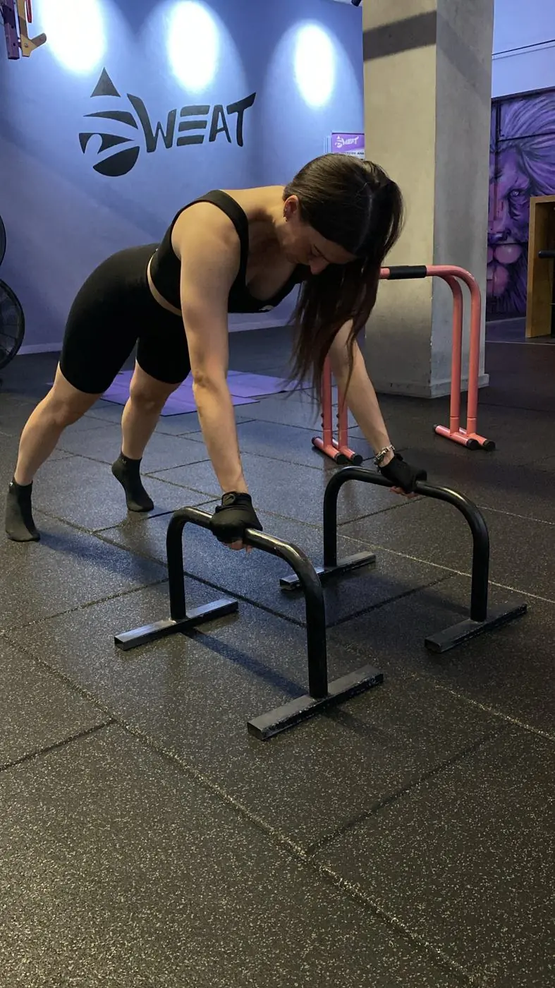 Exercise on low parallettes at SWEAT Studio